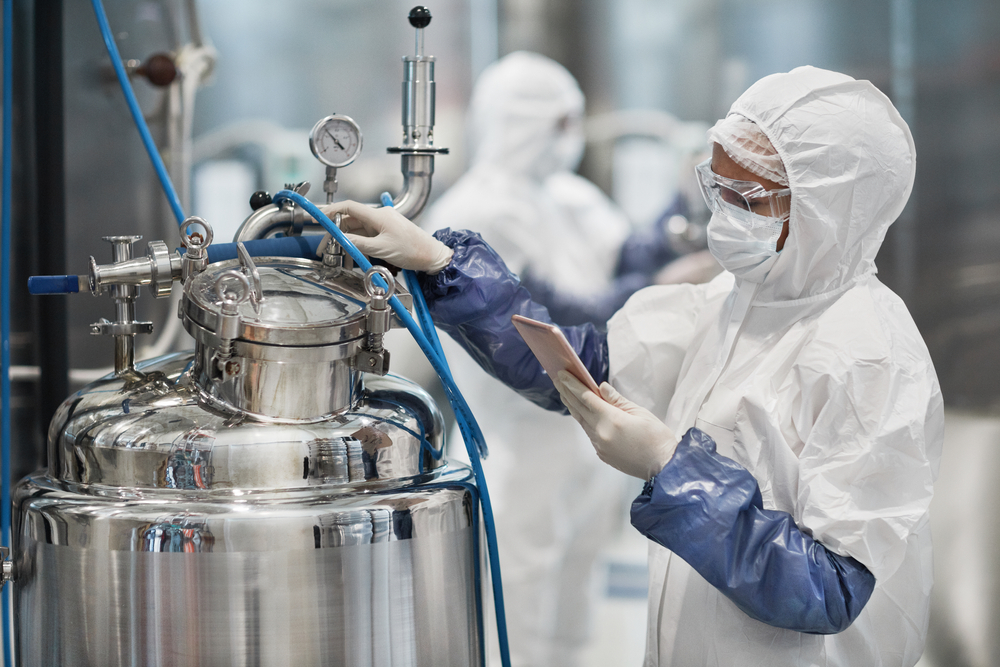 Portrait,Of,Female,Worker,Wearing,Protective,Suit,While,Operating,Equipment