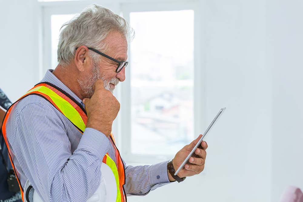 professional senior engieer usign tablet and thinking gesture PSSR checklist