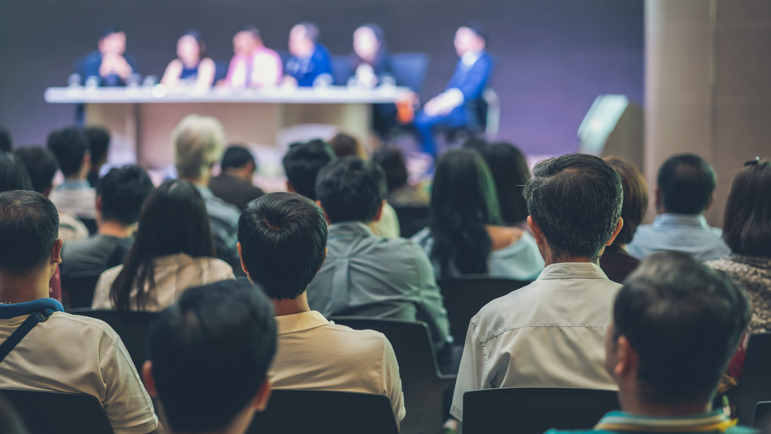 Audience attending a professional conference panel, representing the type of networking and learning opportunities found at top EHS events.