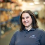 Amy Higgins smiling and wearing a Neograf polo shirt.