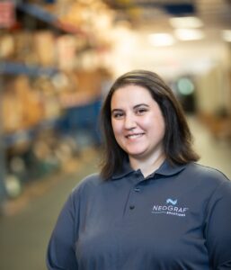 Amy Higgins smiling and wearing a Neograf polo shirt.