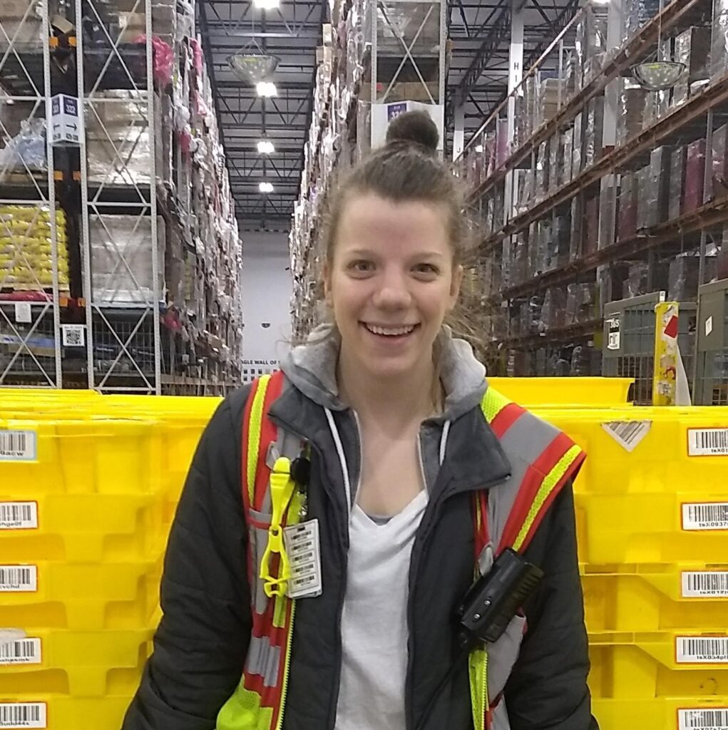 Monica Kinsey standing in front of totes in a warehouse.