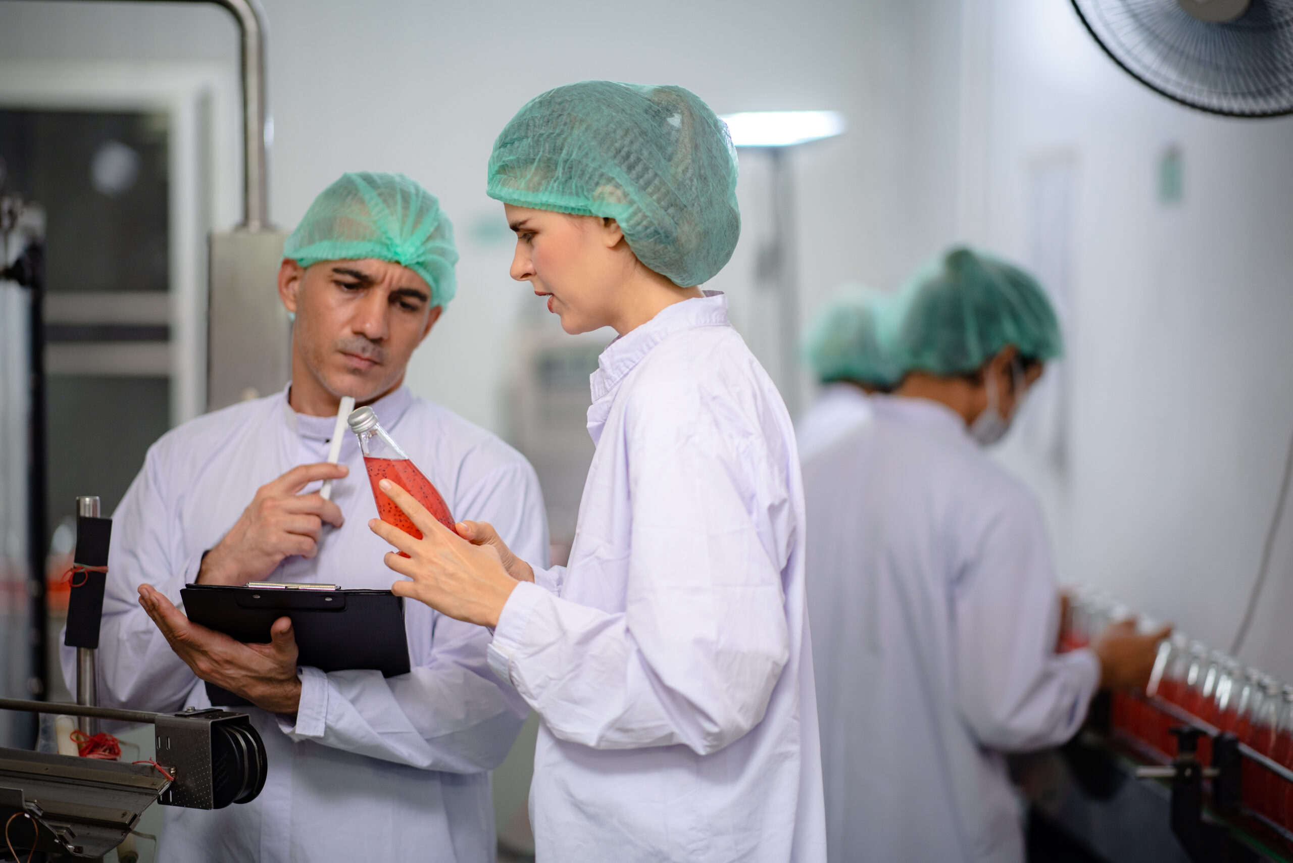 food technician control checking production line of water drink in manufacturing factory