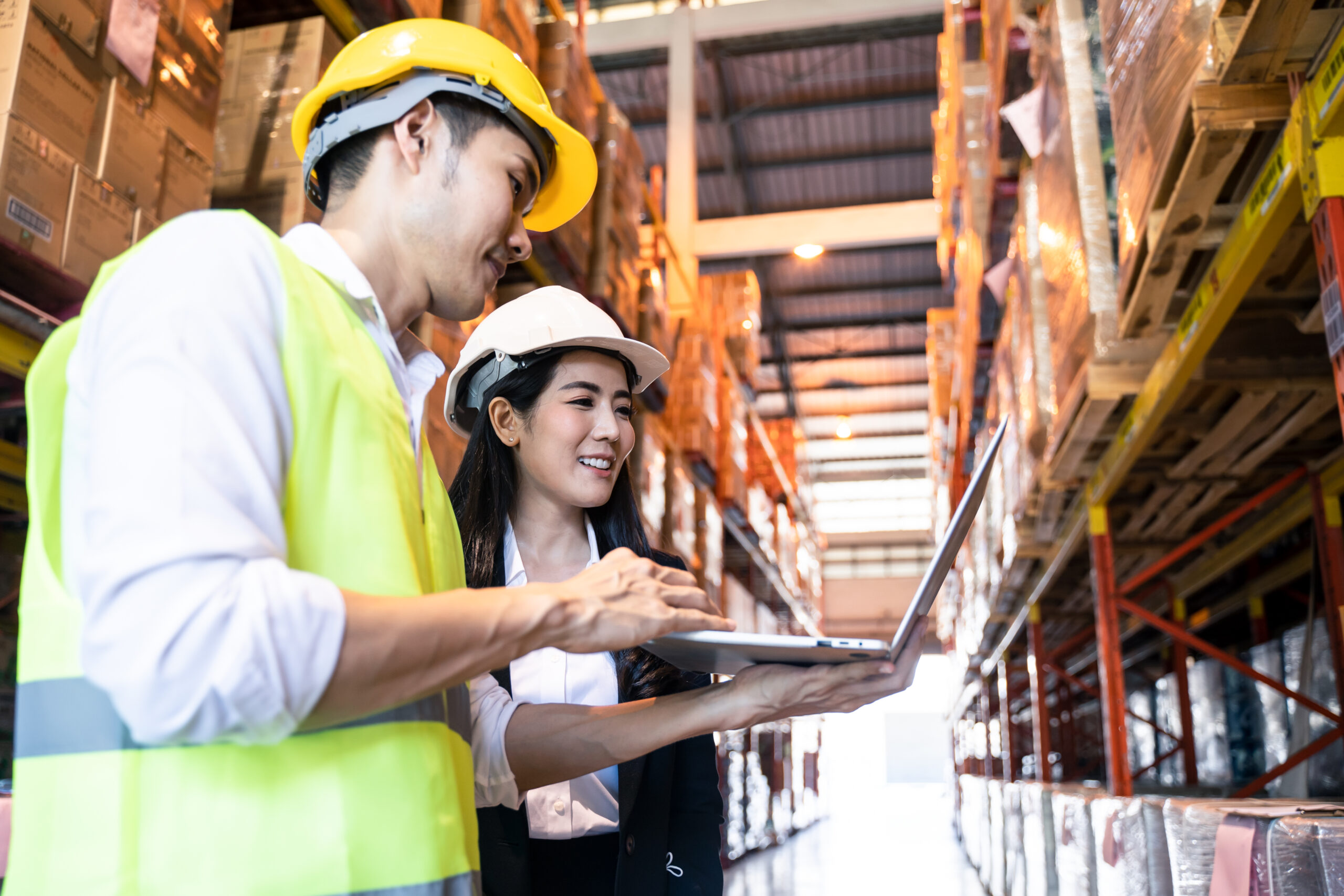 warehouse workers with laptop solving problem