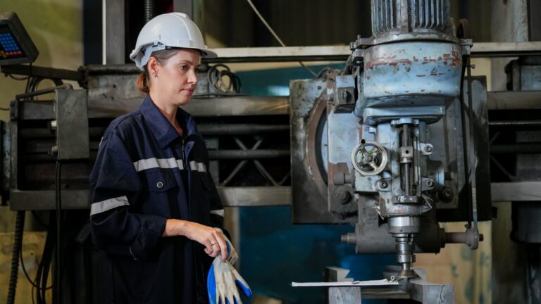 An industrial worker following a change implementation plan outline in a factory