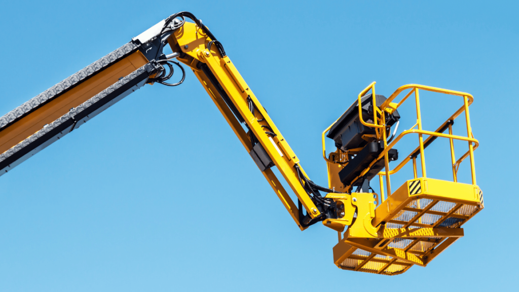 Yellow aerial lift platform extended against a clear blue sky, ideal for illustrating an aerial lift safety toolbox talk focused on equipment handling and fall protection.
