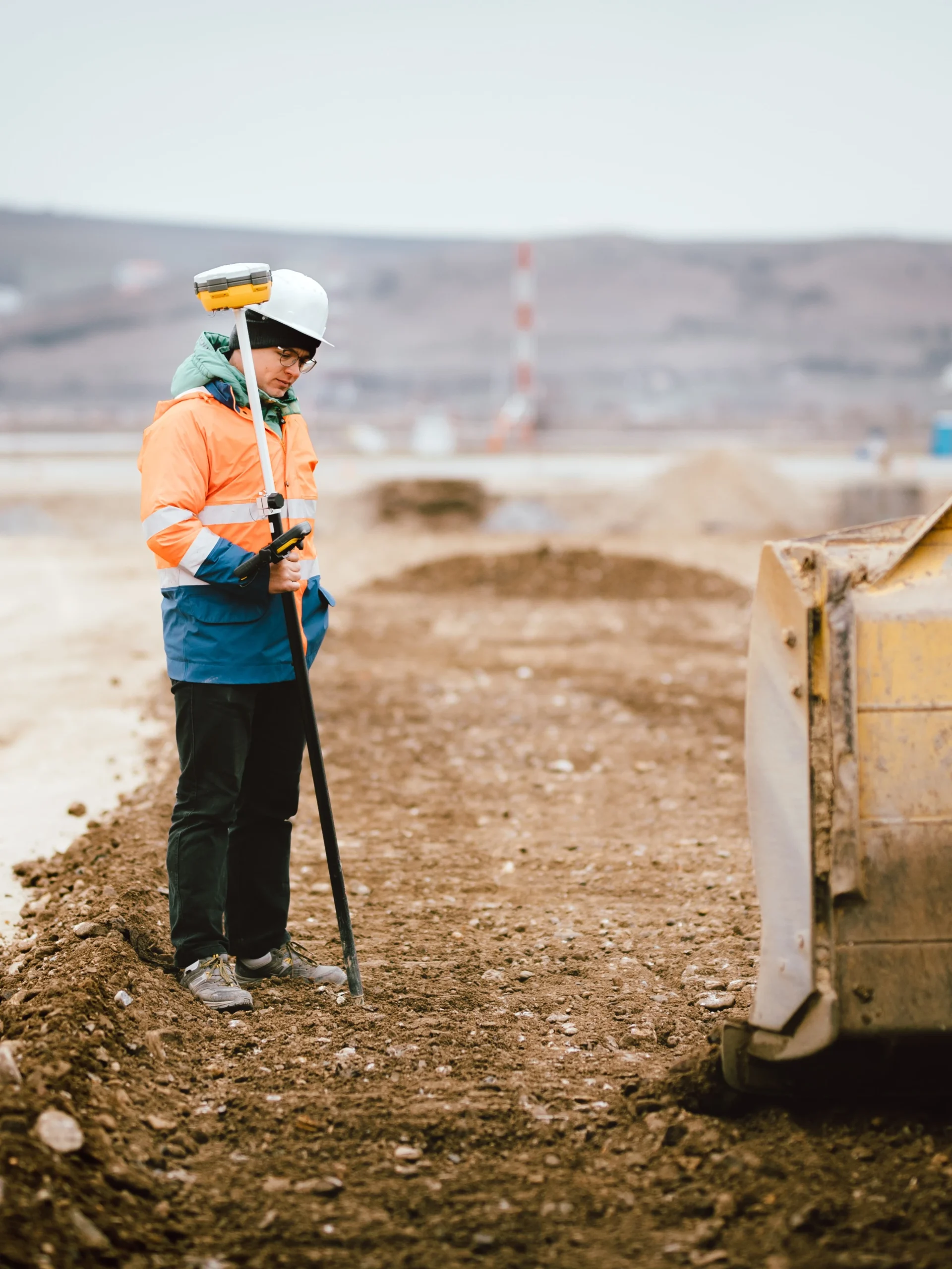 A male construction worker in high visibility clothing.