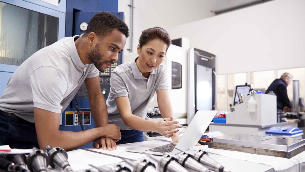 A male and female engineer managing change with MOC software.