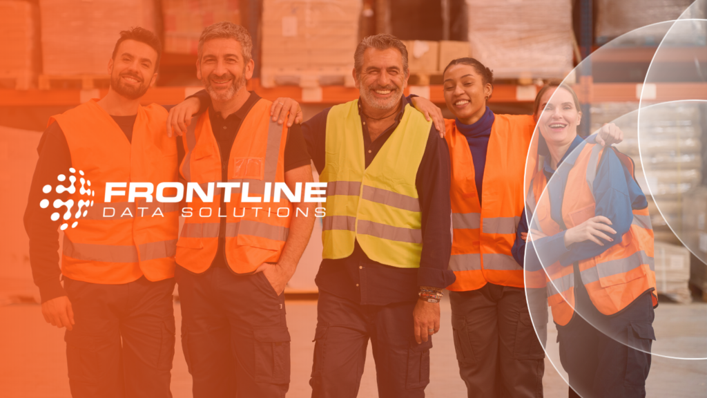 Team of smiling workers in high visibility vests showing the Frontline Data Solutions logo